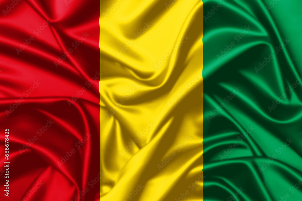 Obraz premium Guinea waving flag close up satin texture background