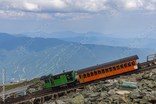 Cogwheel train completing the last and steep stretch on the track to the top of Mt Washington, New Hampshire, USA