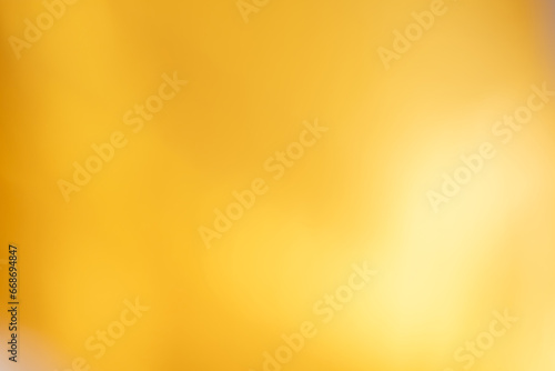 Light luxury golden blurred gradient background has a little abstract light,shadow flash light background, blurred yellow cloth for graphic desig, presentation, blackdrop, wallpaper