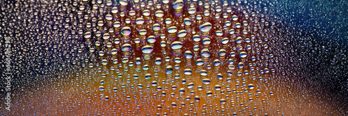 Water drops banner. Many drops abstract background. Colored drop texture. Rainbow gradient. Heavily textured image. Shallow depth of field. Selective focus