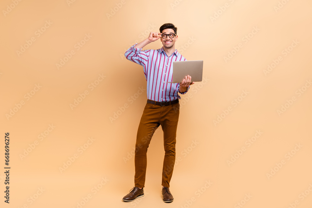 Full length photo of cheerful nice man wear trendy clothes hold eyeglasses look empty space news offer isolated on beige color background Full length photo of cheerful nice man wear trendy clothes hold eyeglasses look empty space news offer isolated on beige color background