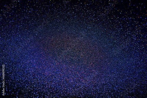Black dark indigo blue gold orange glitter shiny abstract background for design. Twinkling glow stars effect. Fantastic, fantasy. Like outer space, night sky, universe. Grain, rough surface.
