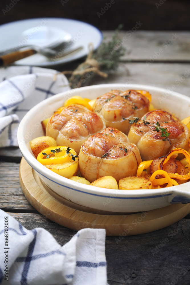 Braised meat paupiettes with potatoes and bell pepper in ceramic bakeware Braised meat paupiettes with potatoes and bell pepper in ceramic bakeware