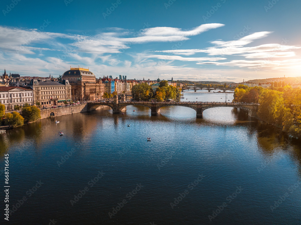 Scenic view of Prague old town on sunset, National Theatre, Vltava River, Legion bridge. Czech Republic