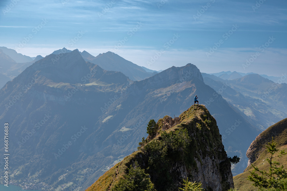 Hiker on top of a mountain in the Alps, Stoos, Schwyz, Switzerland

