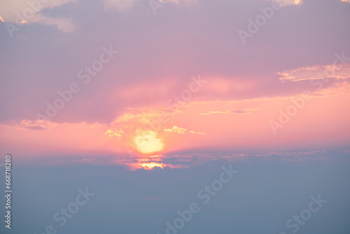 Sunset over the clouds. View from the mountain to the setting sun.