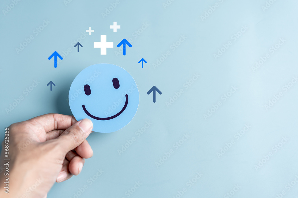 Hands holding blue happy smile face. mental health positive thinking and growth mindset, mental health care recovery to happiness emotion... - obrazy, fototapety, plakaty 
