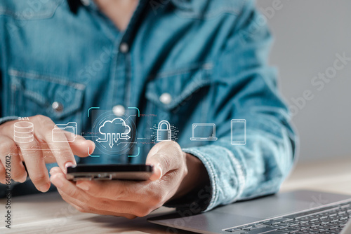 Cloud technology concept. Businessman use smartphone with cloud storage network technology, large network of backup platforms, online data storage for business networks with cyber security software photo