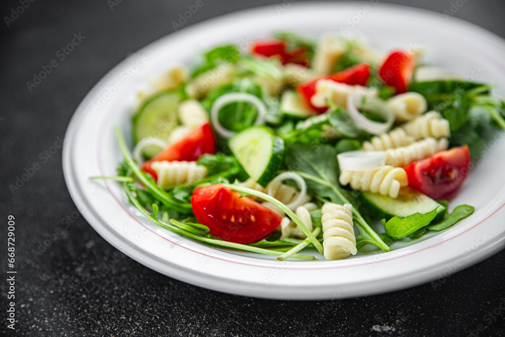 pasta salad fusilli pasta, cucumber, tomato, green lettuce, onion eating appetizer meal food snack on the table copy space food background rustic top view pasta salad fusilli pasta, cucumber, tomato, green lettuce, onion eating appetizer meal food snack on the table copy space food background rustic top view