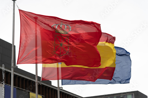 Vista de la bandera de la comunidad foral de Navarra con la bandera española y europea en la ciudad de Pamplona. photo