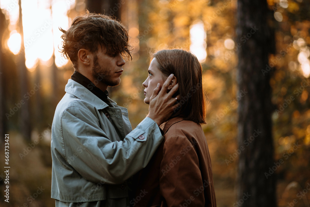beautiful couple of young people in the forest love each other, valentine's day beautiful couple of young people in the forest love each other, valentine's day