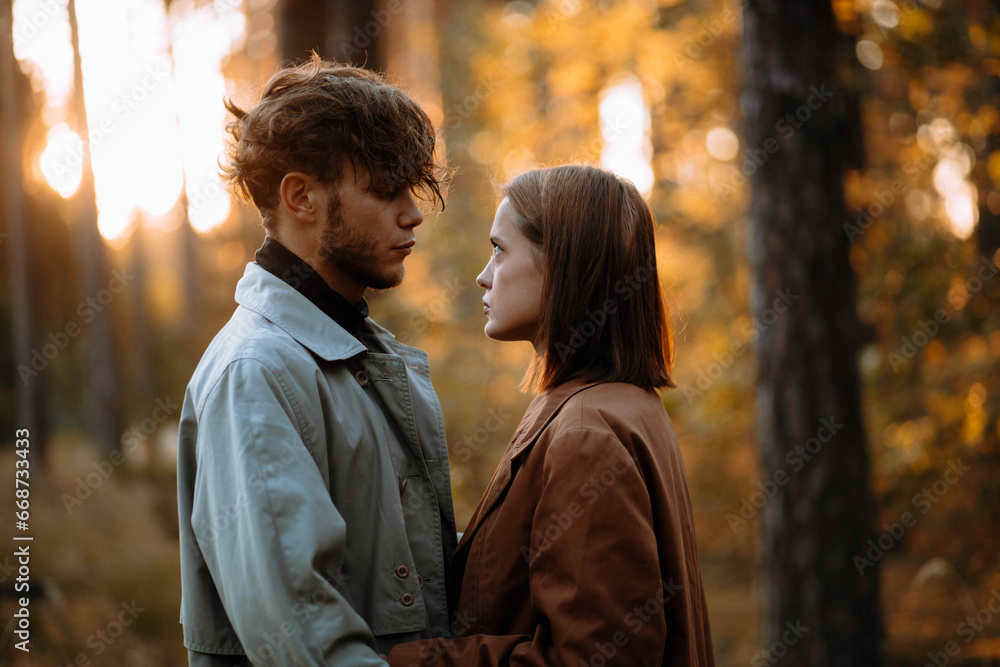 beautiful couple of young people in the forest love each other, valentine's day beautiful couple of young people in the forest love each other, valentine's day