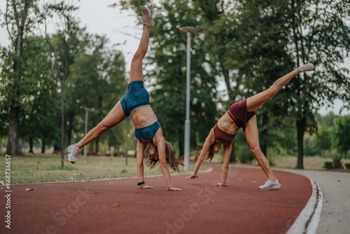 Energetic, Gorgeous, Fit Girls Show Flexibility and Strength in Outdoor Training