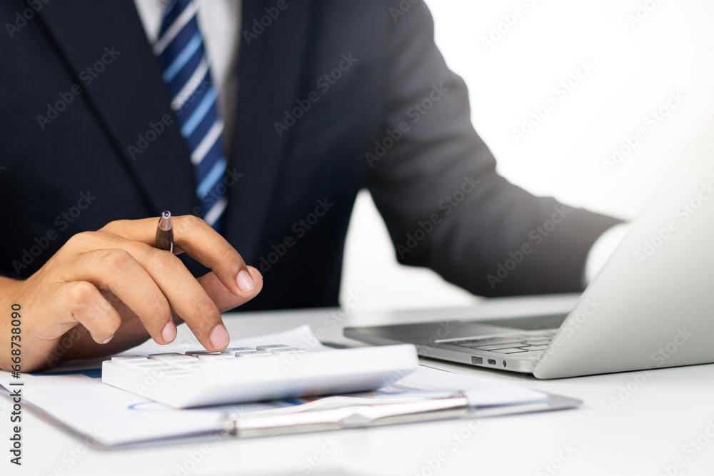 Businessman analyzing financial data for growth, read and write company performance reports, Financial analysis and planning and strategies to maximize sales profits. Businessman analyzing financial data for growth, read and write company performance reports, Financial analysis and planning and strategies to maximize sales profits.