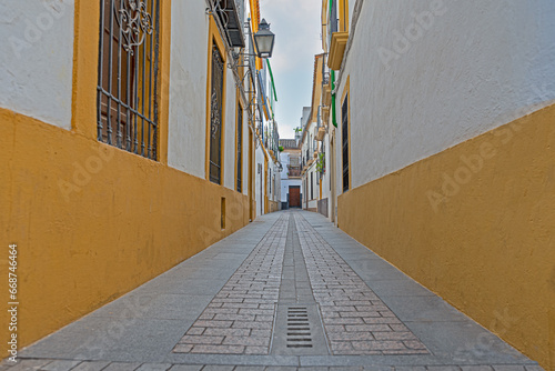 Town street in perspective towards the axis, white and orange photo