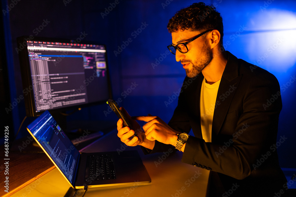 Portrait of young man hold use gadget texting communicate lamp light dark loft room late evening house Portrait of young man hold use gadget texting communicate lamp light dark loft room late evening house