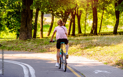 Wallpaper Mural Cyclist ride on the bike path in the city Park Torontodigital.ca