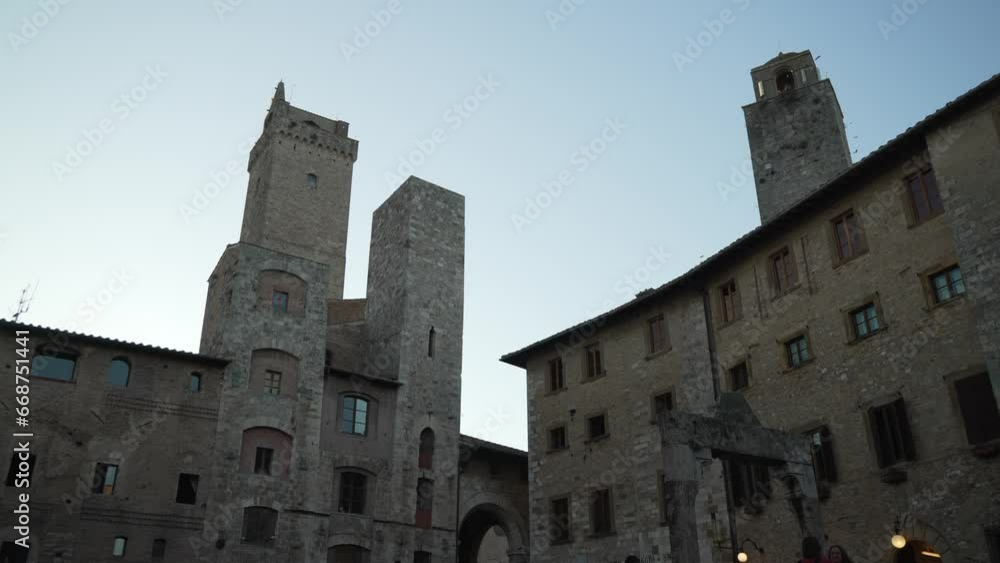 View of towers and restaurants in Piazza della Cisterna in historical centre of San Gimignano, UNESCO World Heritage Site, San Gimignano, Tuscany, Italy View of towers and restaurants in Piazza della Cisterna in historical centre of San Gimignano, UNESCO World Heritage Site, San Gimignano, Tuscany, Italy