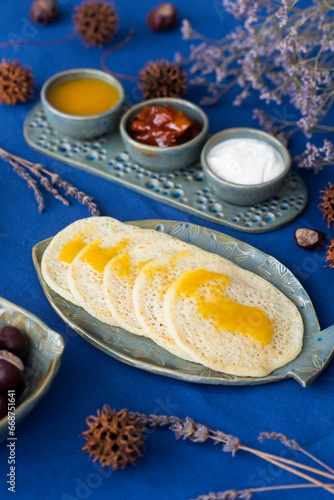 Homemade Moroccan traditional pancakes Baghrir with creamy honey sauce