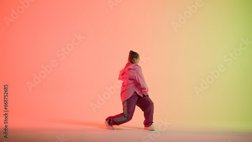 Photography Attractive woman dancing jazz-funk on red and green neon background in a studio