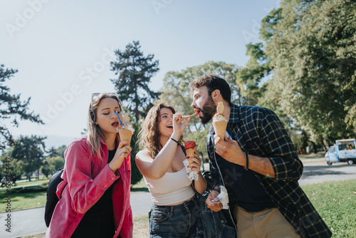 Carefree Friends Enjoying a Sunny Day in the City Park Eating Ice Cream