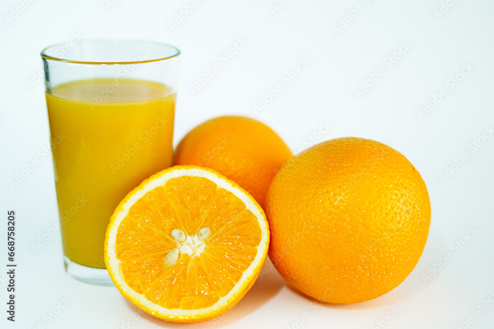 Glas of orange juice wirh oranges and cut open orange with white background. Glas of orange juice wirh oranges and cut open orange with white background.