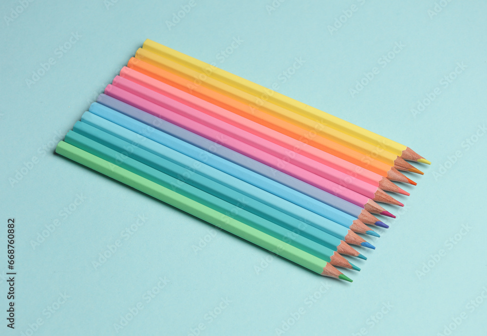 Set of colored pencils on a blue background Set of colored pencils on a blue background