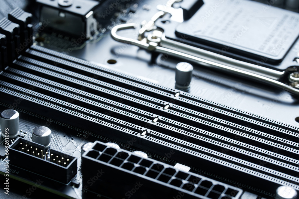 Four slots are connectors for installing DDR5 RAM on the motherboard of a modern computer. Photo Backlighting. Selective focus. Four slots are connectors for installing DDR5 RAM on the motherboard of a modern computer. Photo Backlighting. Selective focus.