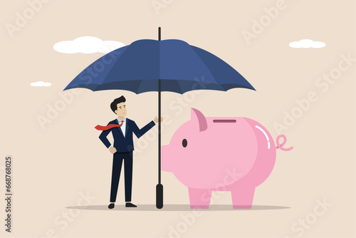 Insurance savings protection, protect finances, confident businessman investor protects his piggy bank with a big umbrella. photo