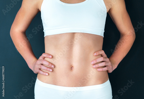 Woman, body and stomach in diet, fitness or health and wellness against a studio background. Closeup of female person or model tummy with hands on hips for self care or natural nutrition on mockup