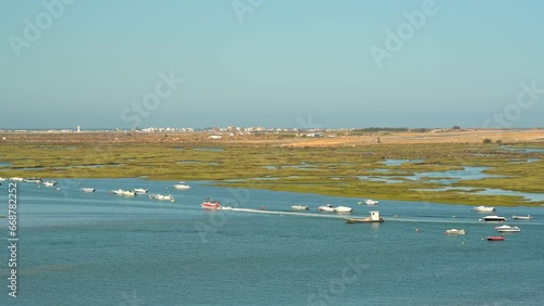 Natural Marine Park of Ria Formosa with boats and the airport in the background.