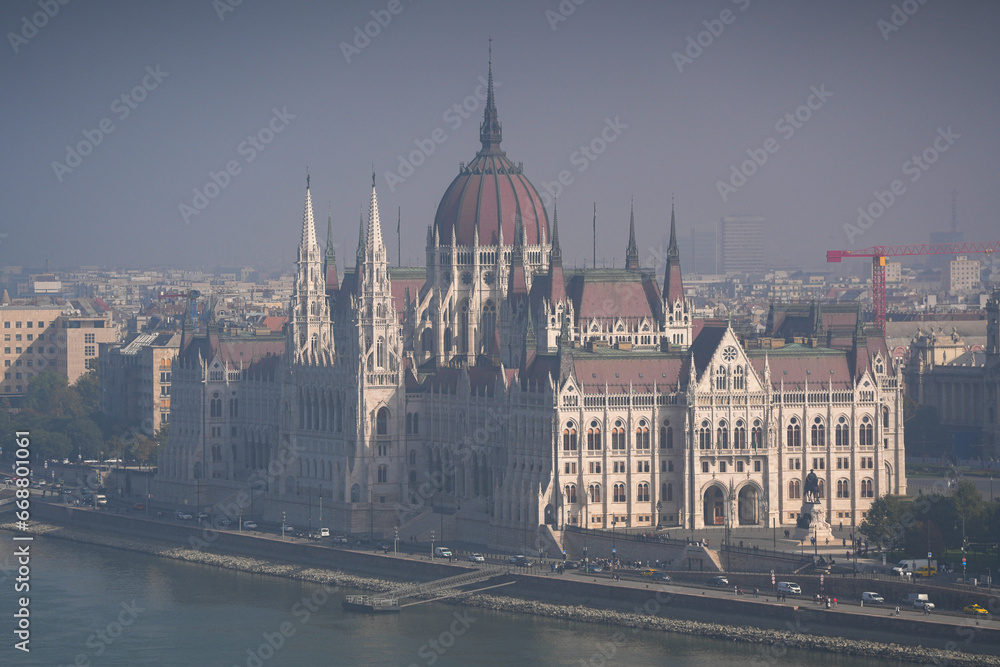 Hungarian Parliament building. View from above over the Budapest Parliament landmark construction, next to Danube river, during a foggy summer morning. Travel to Hungary.