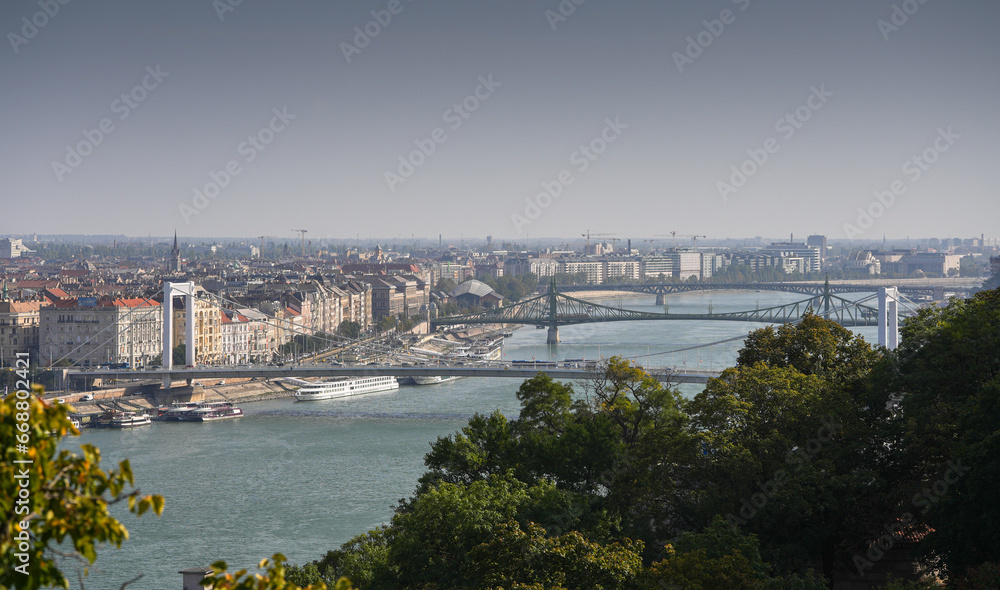 Budapest from above. Wide angle photo with the cityscape of Budapest, capital city of Hungary, during a sunny summer morning. Travel to Budapest, view to bridges and Danube river.
