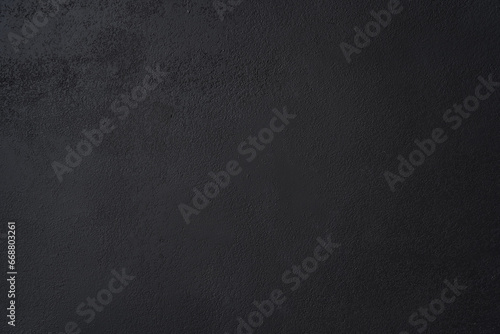 Black wall background made of natural brushstroke, textured old cement or stone. Concrete texture as a Horror and Halloween concept. High quality photo