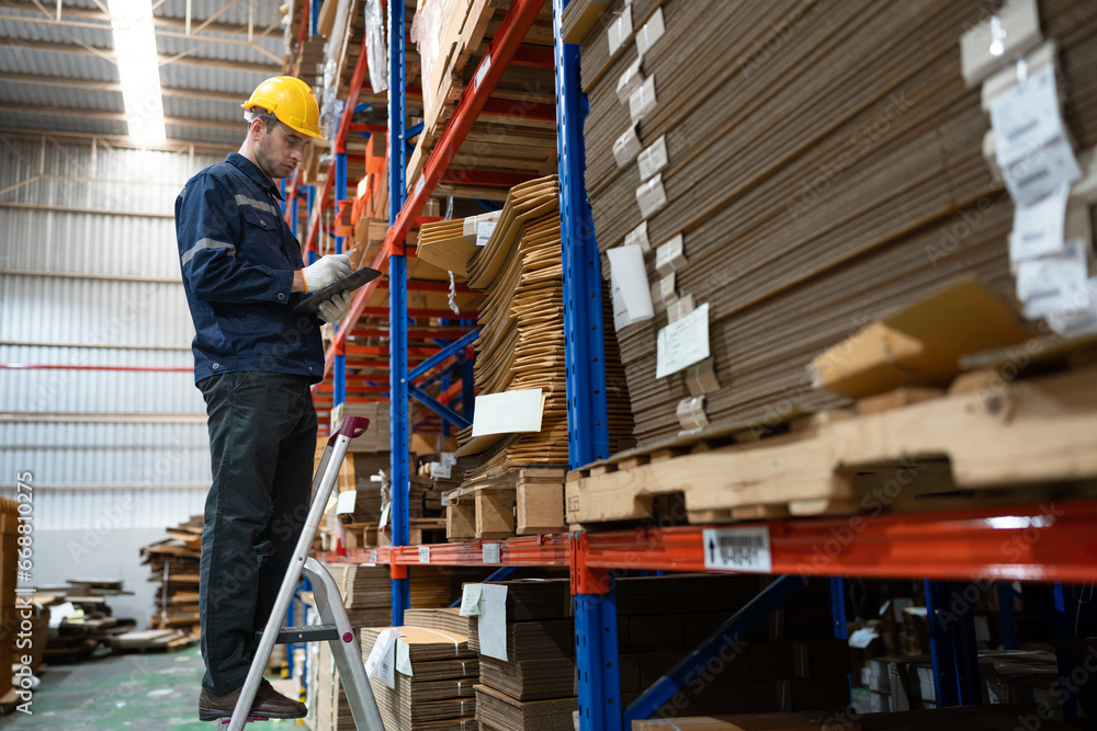 Portrait Caucasian businessman workers using tablet computer checking Kraft paper stock in warehouse Portrait Caucasian businessman workers using tablet computer checking Kraft paper stock in warehouse