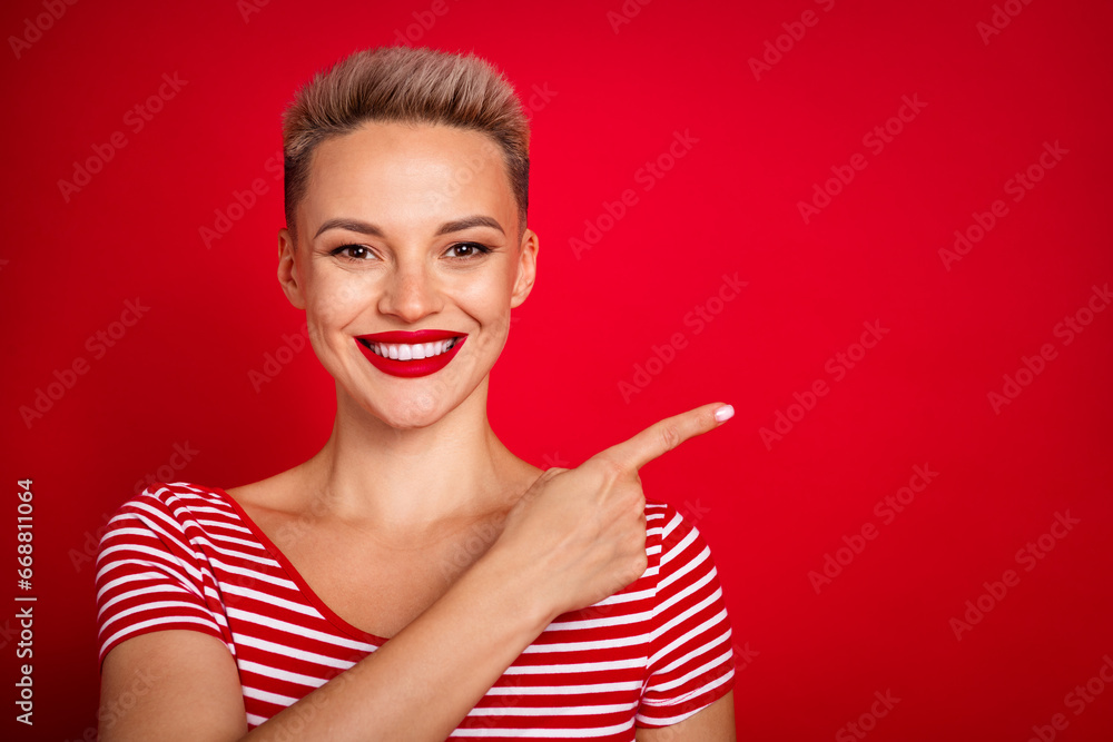 Photo of beautiful pretty woman with dyed haircut directing finger empty space hot proposition to buy isolated on red color background Photo of beautiful pretty woman with dyed haircut directing finger empty space hot proposition to buy isolated on red color background