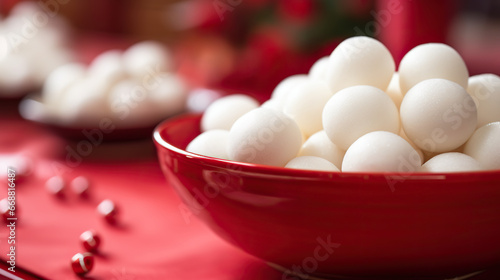 Greeting card for Chinese Dongzhi festival (Winetr Solstice) with tasty tangyuan on red background