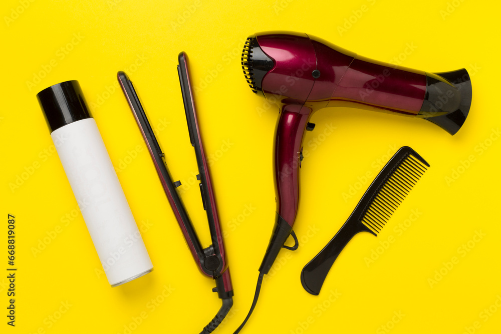 Hair tools with thermo protection on color background, top, view Hair tools with thermo protection on color background, top, view