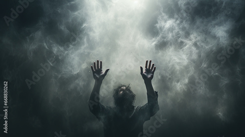 man reaches up through dark clouds, smoke