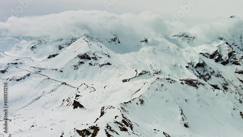 Aerial view of Grossgloknershtrasse in snow. Great high mountain road near Grossglokner mount in Austrian Alps, 4k photo