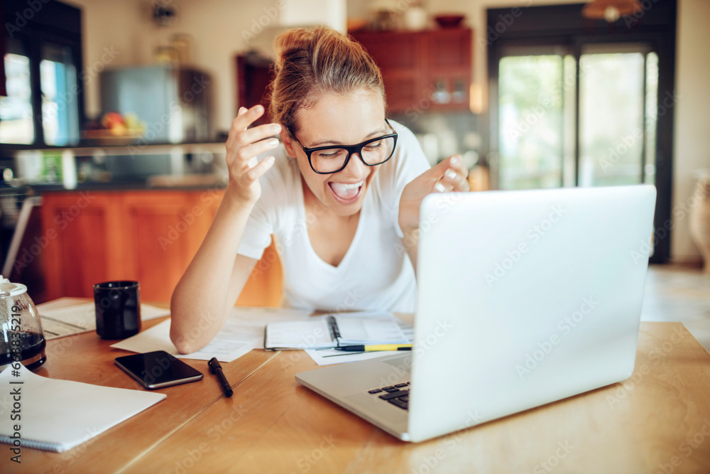 Smiling young woman doing financials at home Smiling young woman doing financials at home