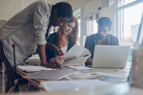 фотографія Diverse trio of designers working in a modern office