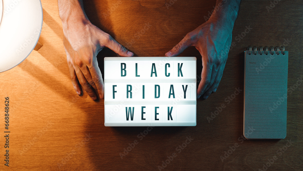Holding Black Friday week sign - obrazy, fototapety, plakaty 