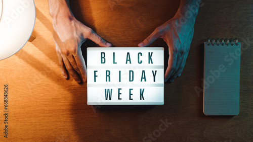 Holding Black Friday week sign photo