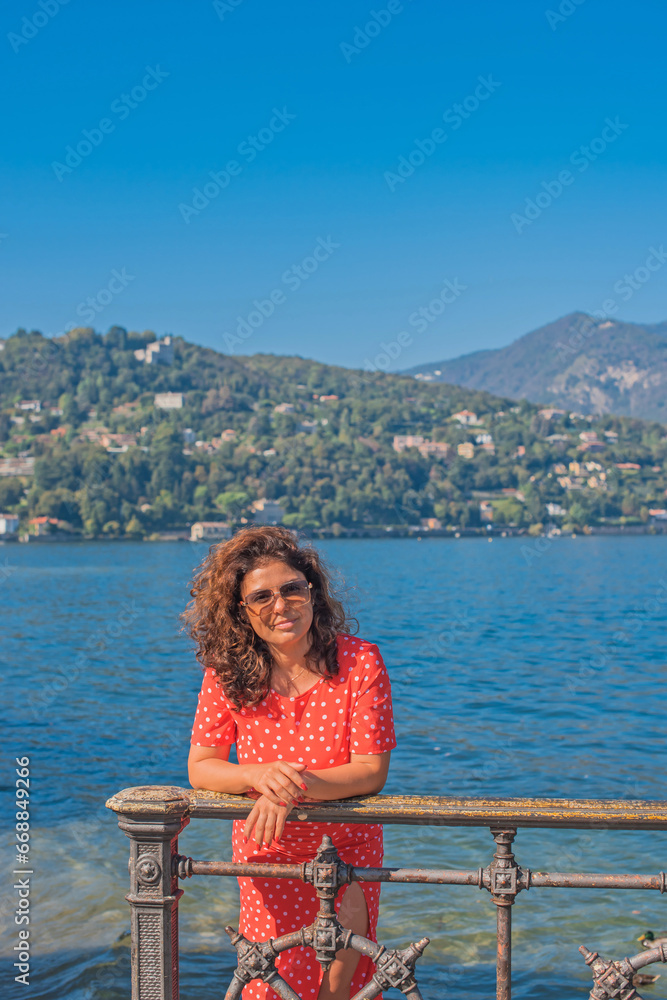 Hispanic woman on vacation - Lake Como views, concept of travel in Italy. Nature landscape. Ideas for journey.