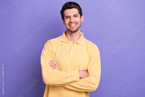 Photo of cheerful good mood guy wear yellow shirt smiling arms crossed isolated violet color background