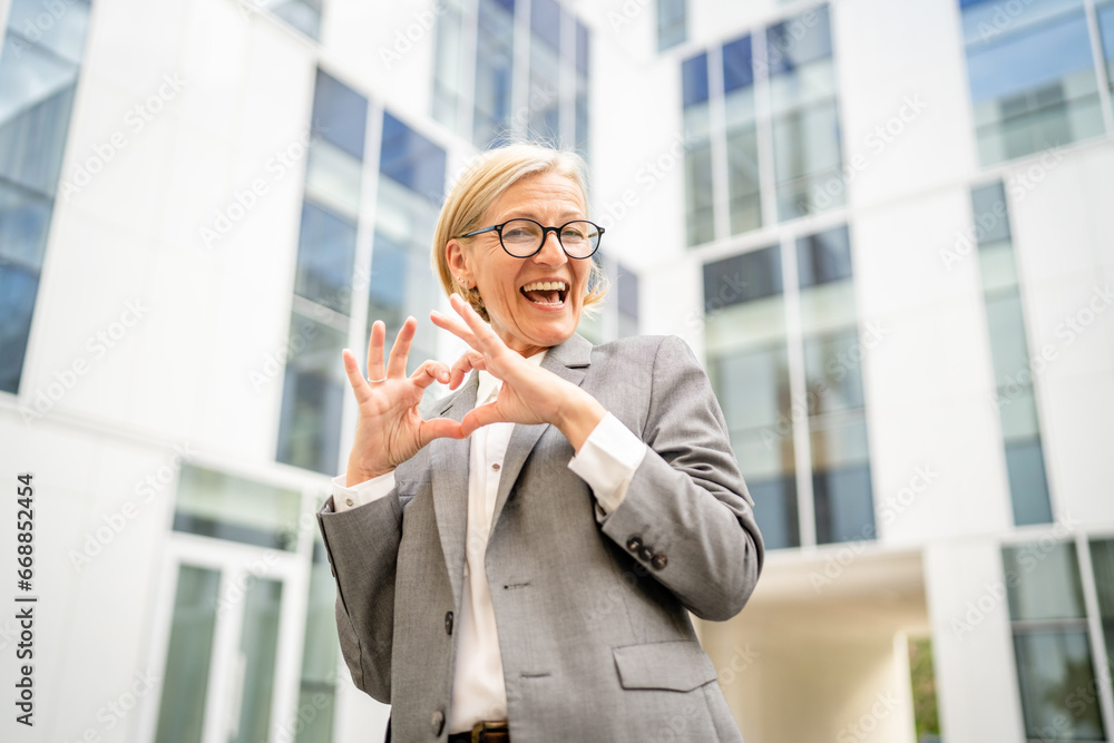 Portrait of one caucasian blonde mature businesswoman stand outdoor Portrait of one caucasian blonde mature businesswoman stand outdoor