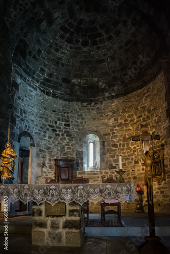 Black interior of the Church of Santa Margherita d Antiochia of altar lighting and religious figures  Vernazza ITALY 