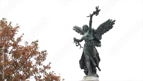 bronze angel statue rome italy with tree photo