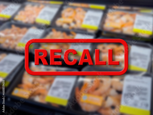 Blurred background of packaged shrimp for sale with the red text Recall in the foreground